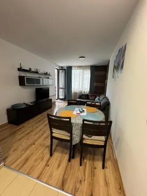 a living room with a table and chairs and a couch at Borovets Gardens MVS Apart D42 in Borovets