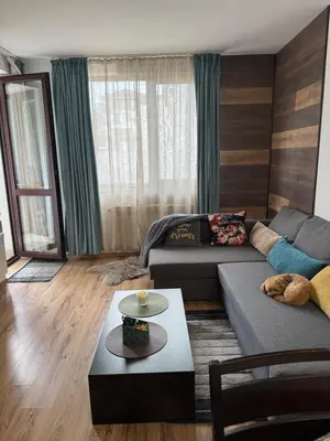 a living room with a couch and a table at Borovets Gardens MVS Apart D42 in Borovets