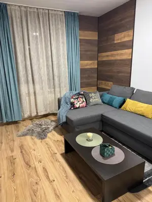 a living room with a couch and a table at Borovets Gardens MVS Apart D42 in Borovets