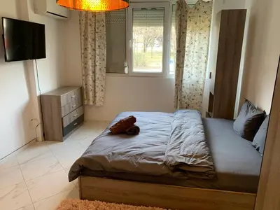 a bedroom with a bed with a teddy bear on it at Urban Nest Lulin in Sofia