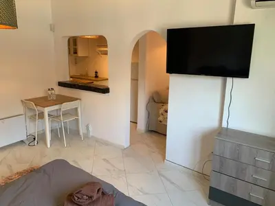 a living room with a flat screen tv on a wall at Urban Nest Lulin in Sofia