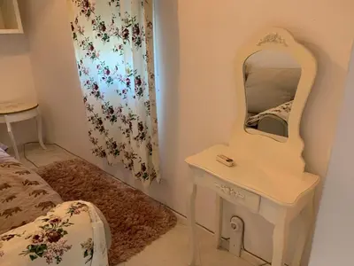 a bedroom with a dressing table and a mirror at Urban Nest Lulin in Sofia