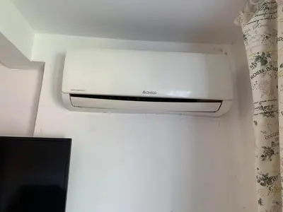 a toaster oven on a wall next to a curtain at Urban Nest Lulin in Sofia