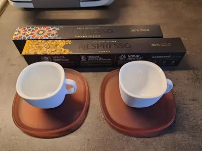 two cups sitting on plates next to a box at Rila Mountain Design Studio, Borovets, Shiroka poliana 216 in Borovets