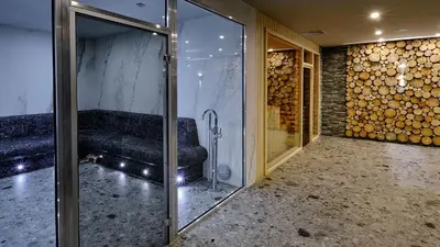 a room with a couch and a glass door at Luxfjäll Ivan Rilski - Full Spa & Pool in Bansko
