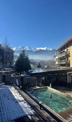 a swimming pool in front of a building at Luxfjäll Ivan Rilski - Full Spa & Pool in Bansko