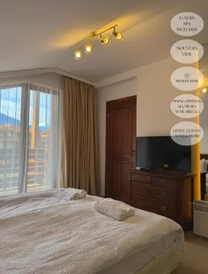 a bedroom with a large bed and a television at Luxfjäll Ivan Rilski - Full Spa & Pool in Bansko