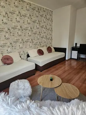 a living room with a couch and a table at City Center Park Apartment in Sofia