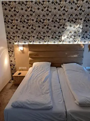 a bedroom with a bed and a wall with hearts at ВасиленаАпарт in Pamporovo