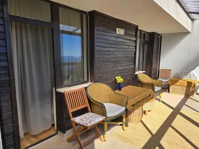 a patio with chairs and a table on a balcony at Pampo-Heaven in Smolyan