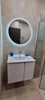 a bathroom with a white sink and a mirror at MariGold Apartments in Sandanski