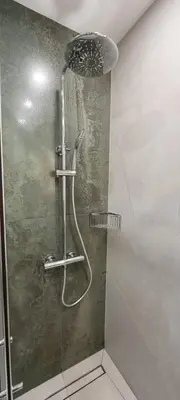 a shower with a shower head in a bathroom at MariGold Apartments in Sandanski