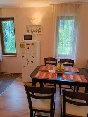 a kitchen and dining room with a table and chairs at Evrika home 4 in Pamporovo