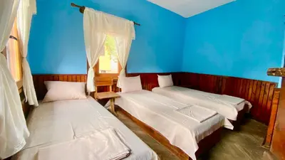 a room with two beds and a blue wall at Туристическа спалня Богдан in Koprivshtitsa