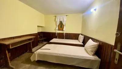 a bedroom with two beds and a window at Туристическа спалня Богдан in Koprivshtitsa