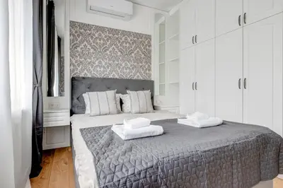 a bedroom with a large bed with two towels on it at Quiet One-Bedroom Hеaven Relax and Unwind in Sofia