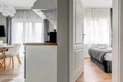 a room with a bed and a kitchen with a door at Quiet One-Bedroom Hеaven Relax and Unwind in Sofia