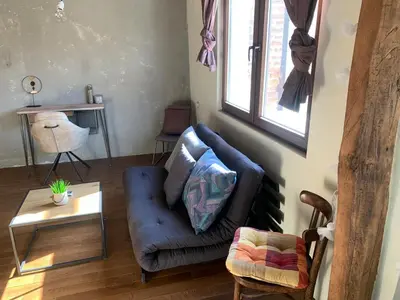 a living room with a blue couch and a table at Graf's Prestige Duplex in Sofia