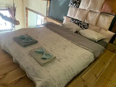 a large bed with two towels on top of it at Graf's Prestige Duplex in Sofia
