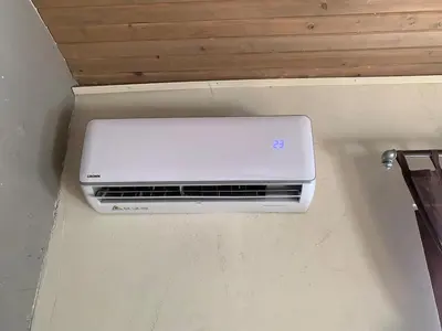 a white air conditioner on a wall in a room at Graf's Prestige Duplex in Sofia