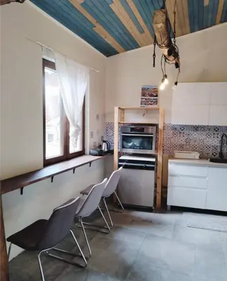 a kitchen with chairs and a table and a stove at Graf's Prestige Duplex in Sofia