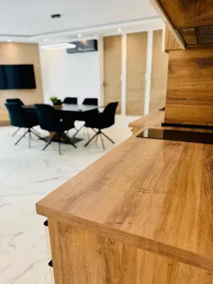 a wooden counter in a room with chairs and a table at luxuri suite ''dezodava'' in Sandanski