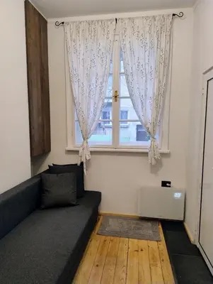a living room with a couch and a window at Tiny studio in top center in Sofia
