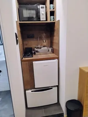 a kitchen with a sink and a microwave at Tiny studio in top center in Sofia