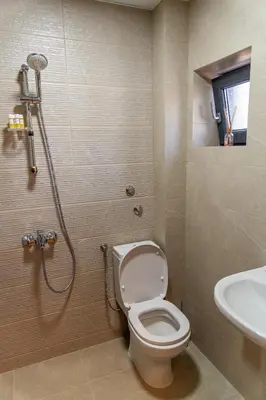 a bathroom with a shower and a toilet and a sink at Семеен Хотел Олимп in Sopot