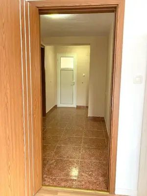 an empty hallway with a door and a tile floor at Apartment Park View in Sandanski