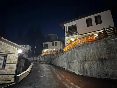 a street at night with a building and lights at Комплекс БОЖИДАРИЦА in Progled