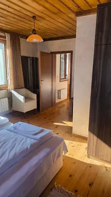 a bedroom with a bed and a chair in a room at Комплекс БОЖИДАРИЦА in Progled