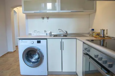 a kitchen with a washing machine and a sink at Tatyana City garden in Plovdiv