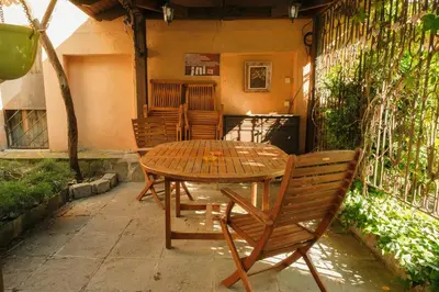 a wooden table and chairs on a patio at Tatyana City garden in Plovdiv