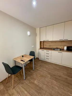 a kitchen with a table and two chairs and a table and a counter at Music Flats in Sofia