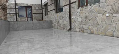 a stone building with a stone wall and a patio at Modern apartment with terrace in Chepelare