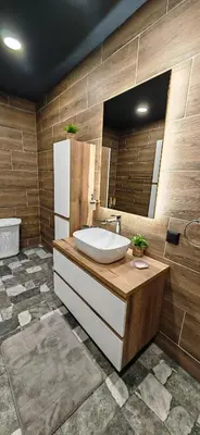 a bathroom with a sink and a refrigerator at Modern apartment with terrace in Chepelare