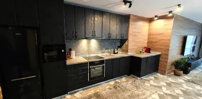 a kitchen with black cabinets and a sink at Modern apartment with terrace in Chepelare
