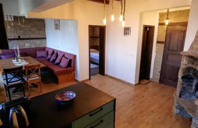 a living room with a couch and a table at Трите къщи in Leshten