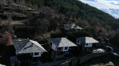 an aerial view of houses in a mountain at Трите къщи in Leshten