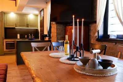 a dining room table with candles on top of it at Трите къщи in Leshten