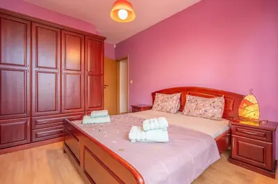a bedroom with a large bed with pink walls at Central Sofia Retreat in Sofia