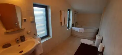 a bathroom with a sink and a toilet and a window at Apartment for guests in Bansko