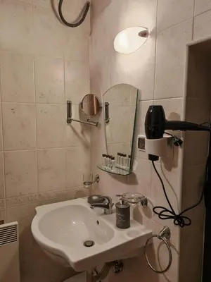 a bathroom with a sink and a mirror at Apartment for guests in Bansko