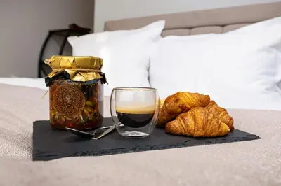 a tray with a glass of jam and croissants on a bed at Happy People 2 BD, Central Plovdiv by Flat Mаnager in Plovdiv