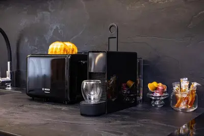 a microwave sitting on a counter with a pumpkin on top at Happy People 2 BD, Central Plovdiv by Flat Mаnager in Plovdiv
