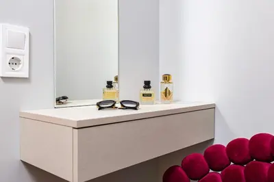 a dressing table with a mirror and a pile of red balls at Happy People 2 BD, Central Plovdiv by Flat Mаnager in Plovdiv