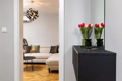 a living room with a couch and a table with red tulips at Happy People 2 BD, Central Plovdiv by Flat Mаnager in Plovdiv
