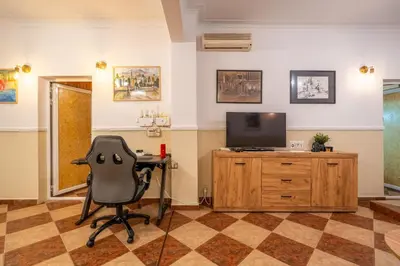 an office with a chair and a desk and a television at Belle Epoque-Sofia-Free parking in Sofia