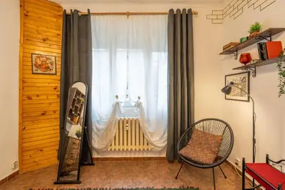 a room with a window with a radiator and a chair at Belle Epoque-Sofia-Free parking in Sofia